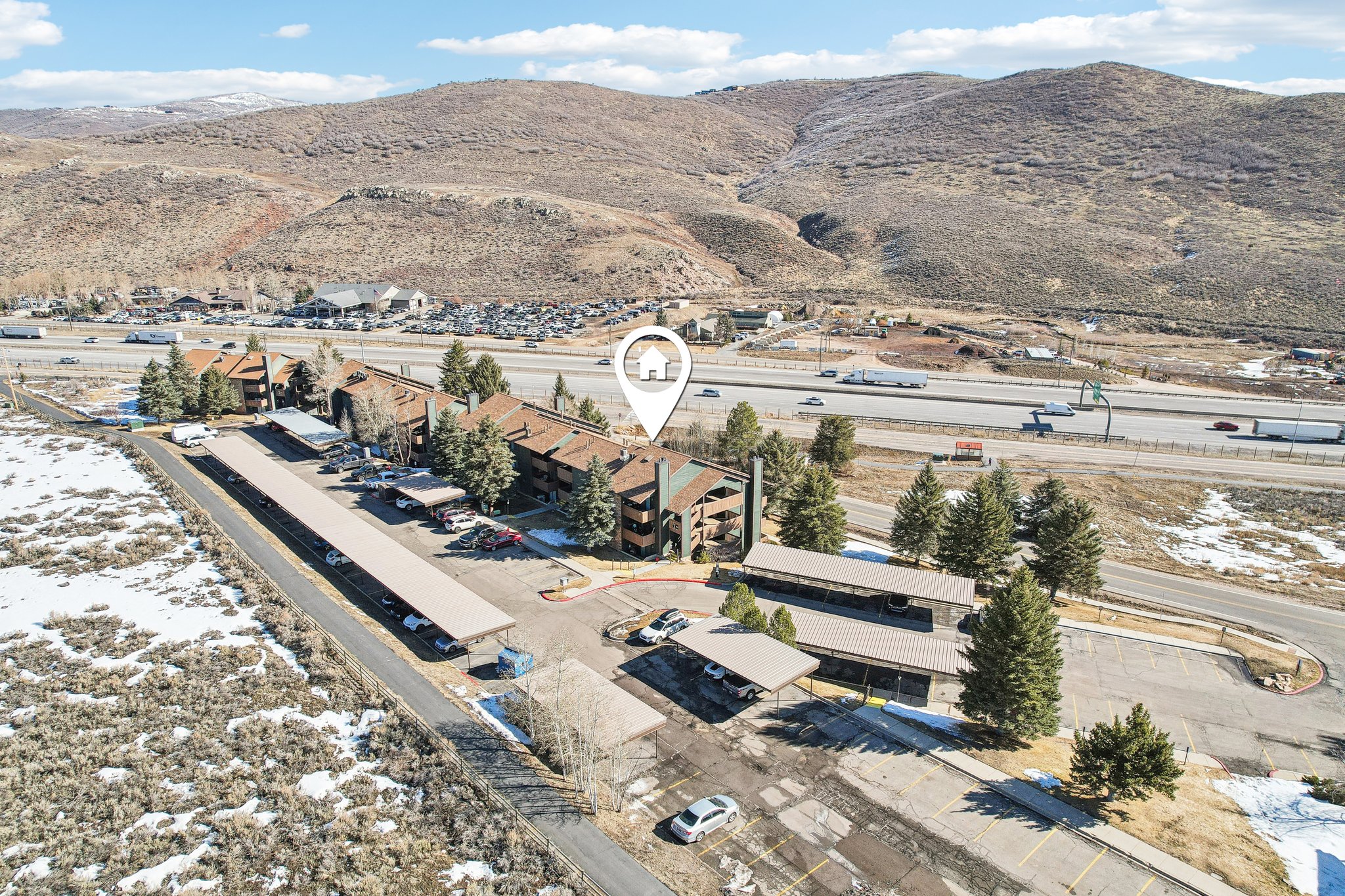 View of property location featuring mountains and nearby suburban area