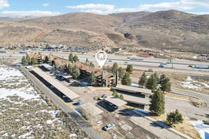 View of property location featuring mountains and nearby suburban area