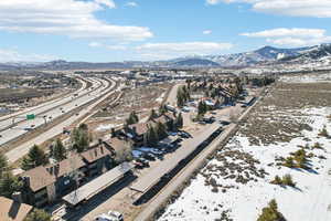 Aerial perspective of suburban area featuring mountains and a main thoroughfare