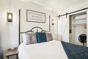 Bedroom with a barn door and a closet