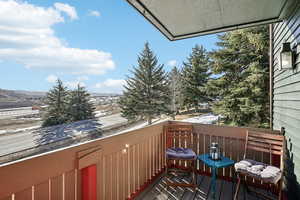 View of snow covered back of property