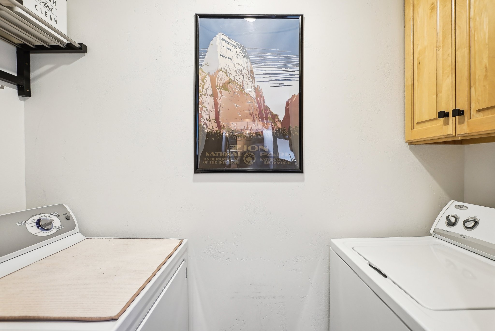 Laundry area featuring washing machine and dryer and cabinet space