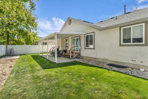 Back of house featuring a patio area and stucco siding