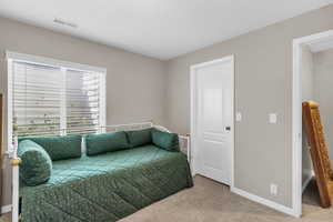 Bedroom with baseboards and light colored carpet