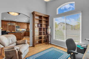 Office space featuring light hardwood floors and arched walkways