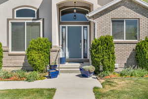 Inviting entry to property with brick and stucco siding