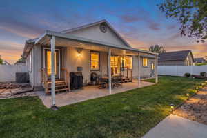 Back of property featuring a fenced backyard, a patio area, and stucco siding