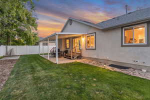 Rear view of house with a covered patio area and stucco siding
