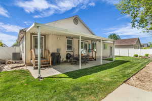 Fully fenced back of property featuring a patio area, a gate, and entry steps