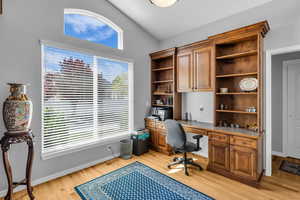 Office area featuring vaulted ceiling, hardwood floors plenty of natural light