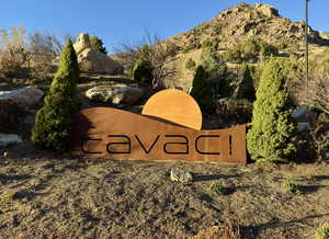 Community / neighborhood sign featuring a mountain view