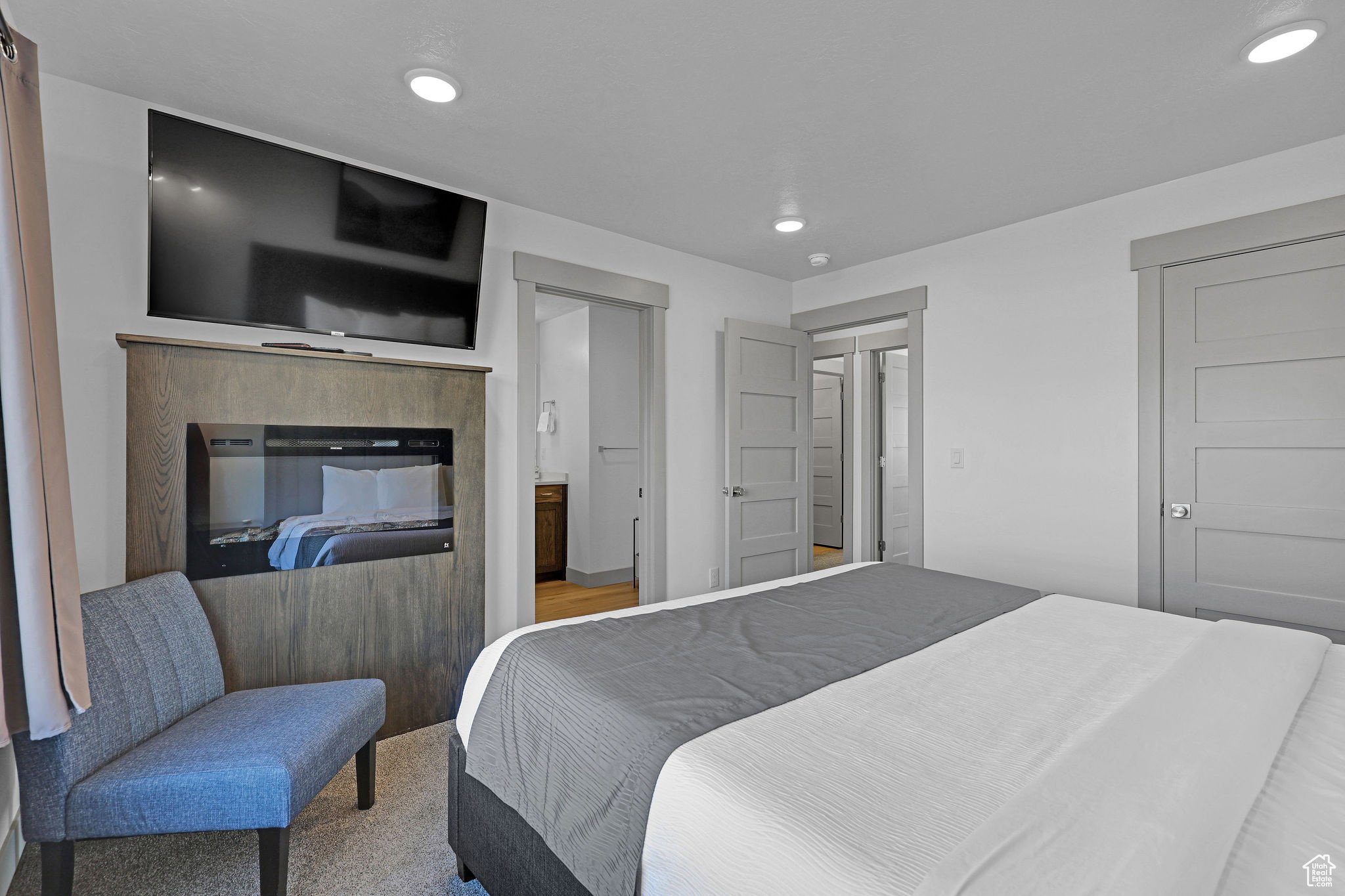 Carpeted bedroom with recessed lighting