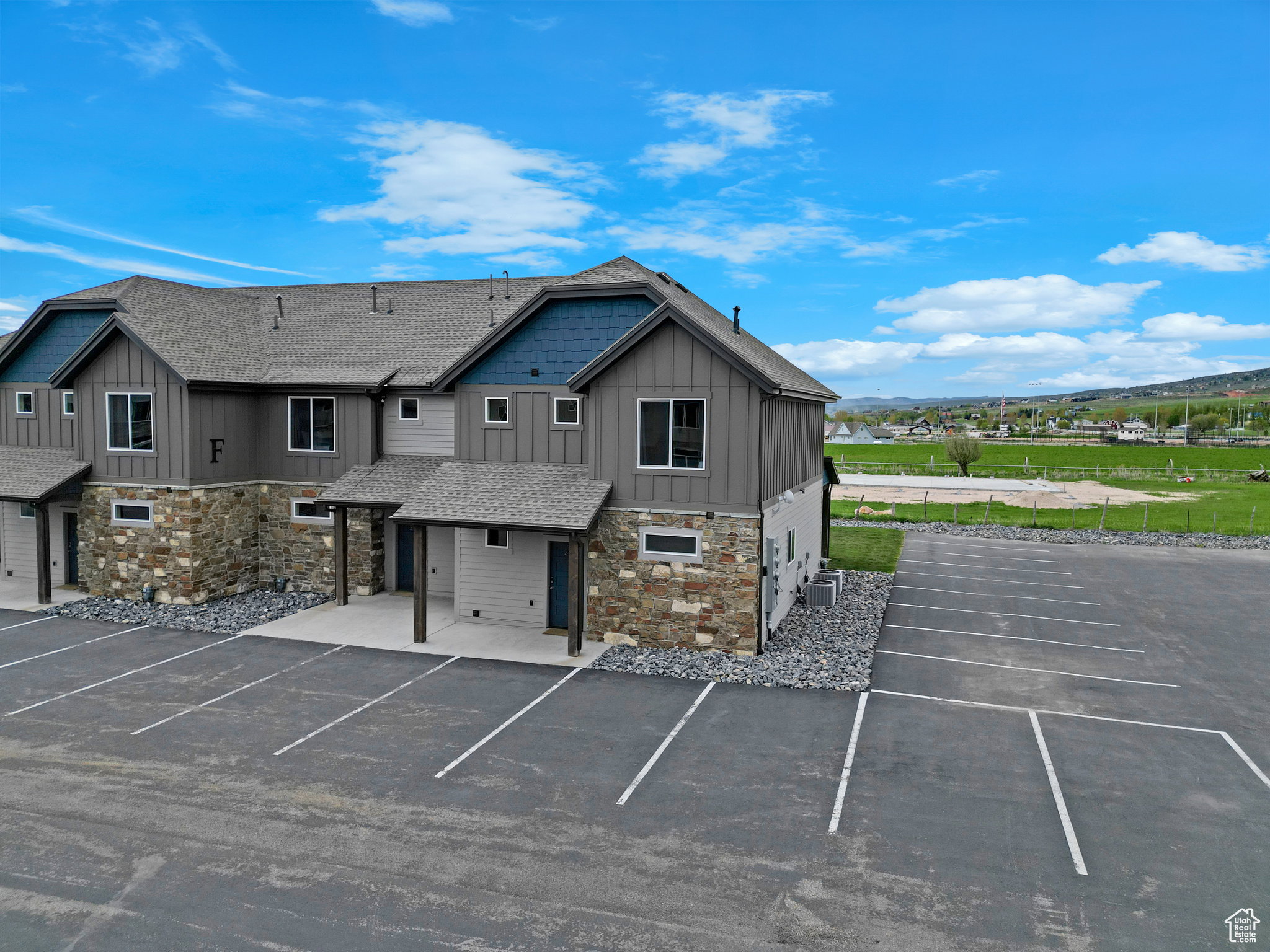 View of building exterior with uncovered parking