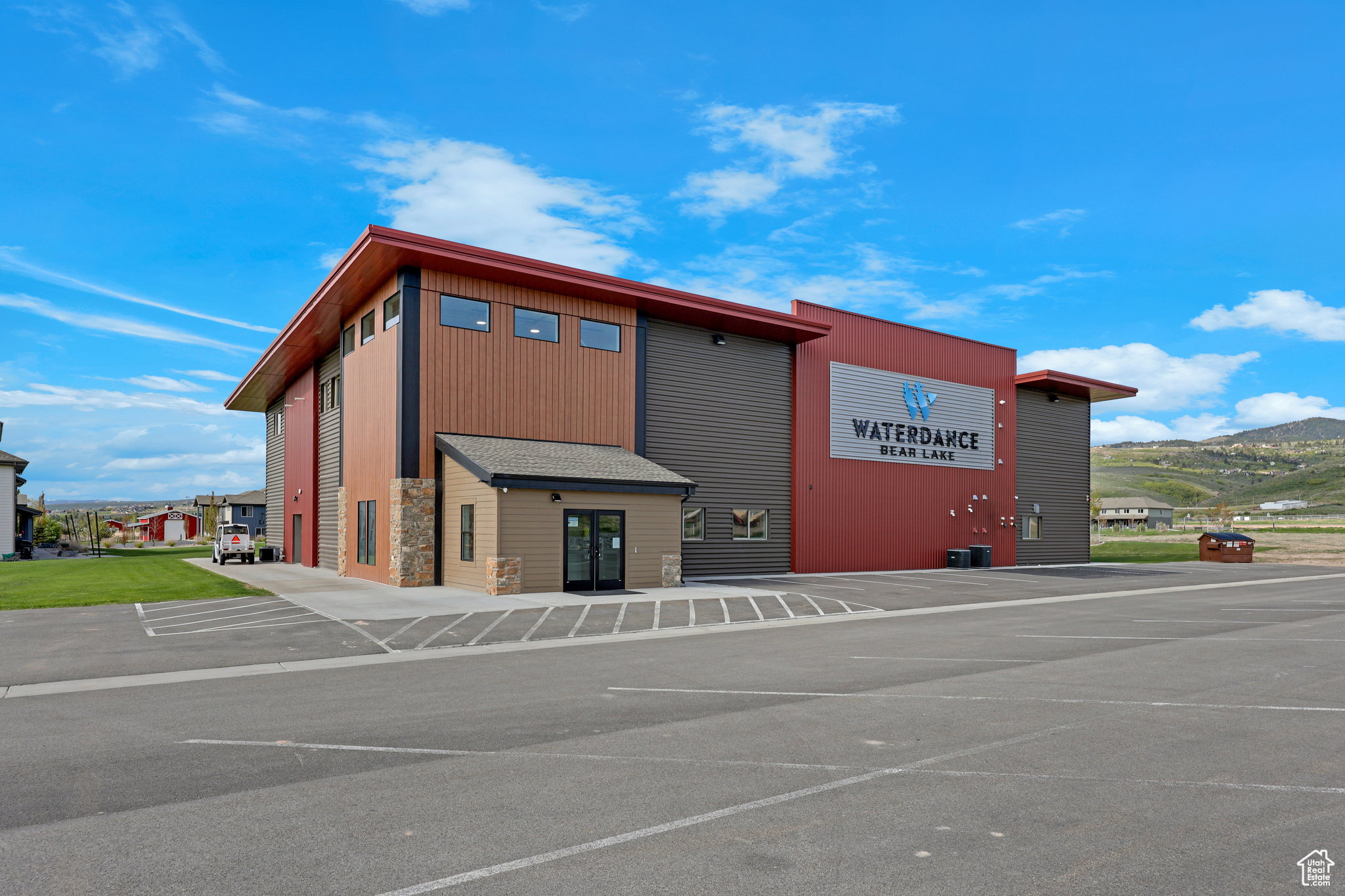View of commercial property with uncovered parking