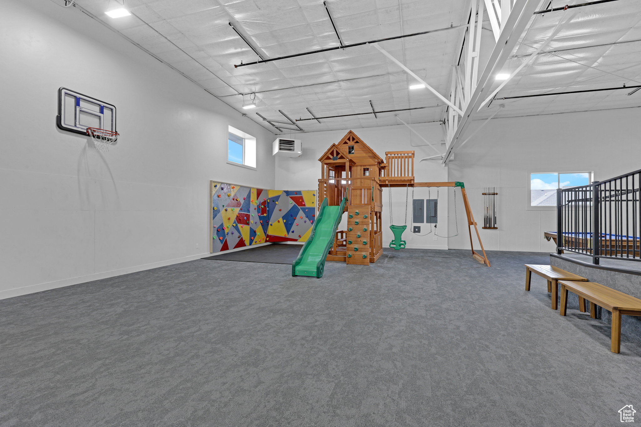 Recreation room with healthy amount of natural light, a high ceiling, and a heating unit