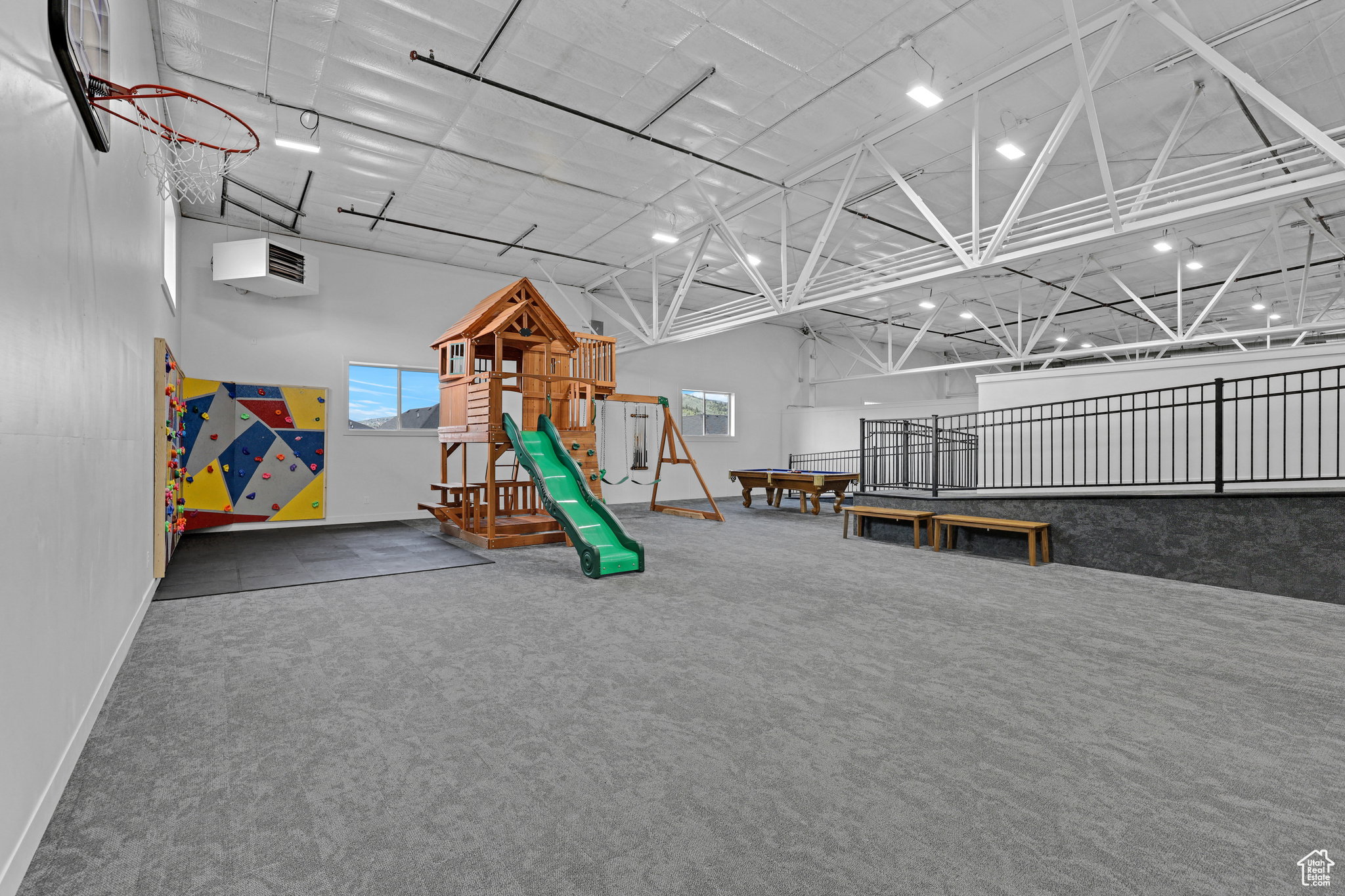 Game room with a heating unit and a high ceiling