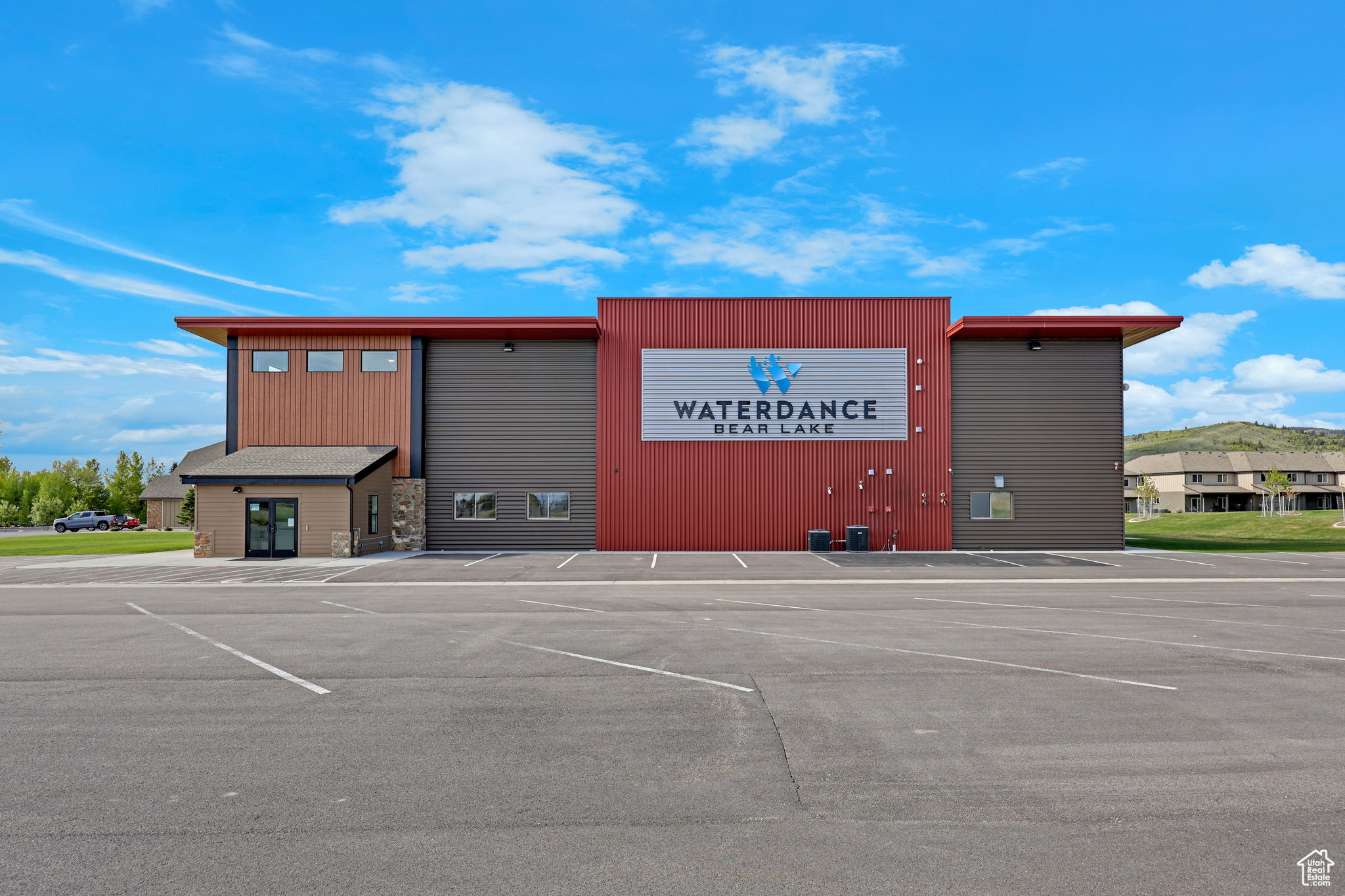 View of commercial property featuring uncovered parking