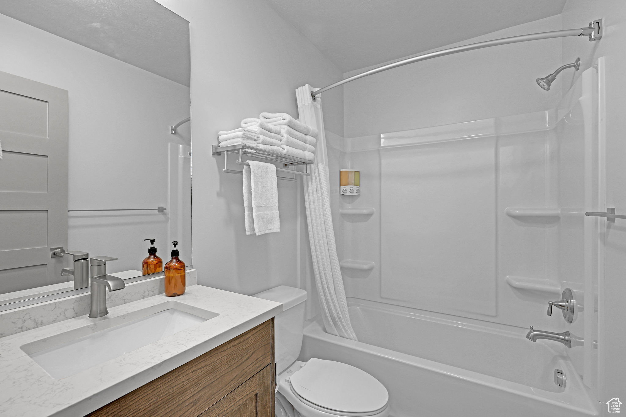 Bathroom with vanity and shower / bath combination with curtain