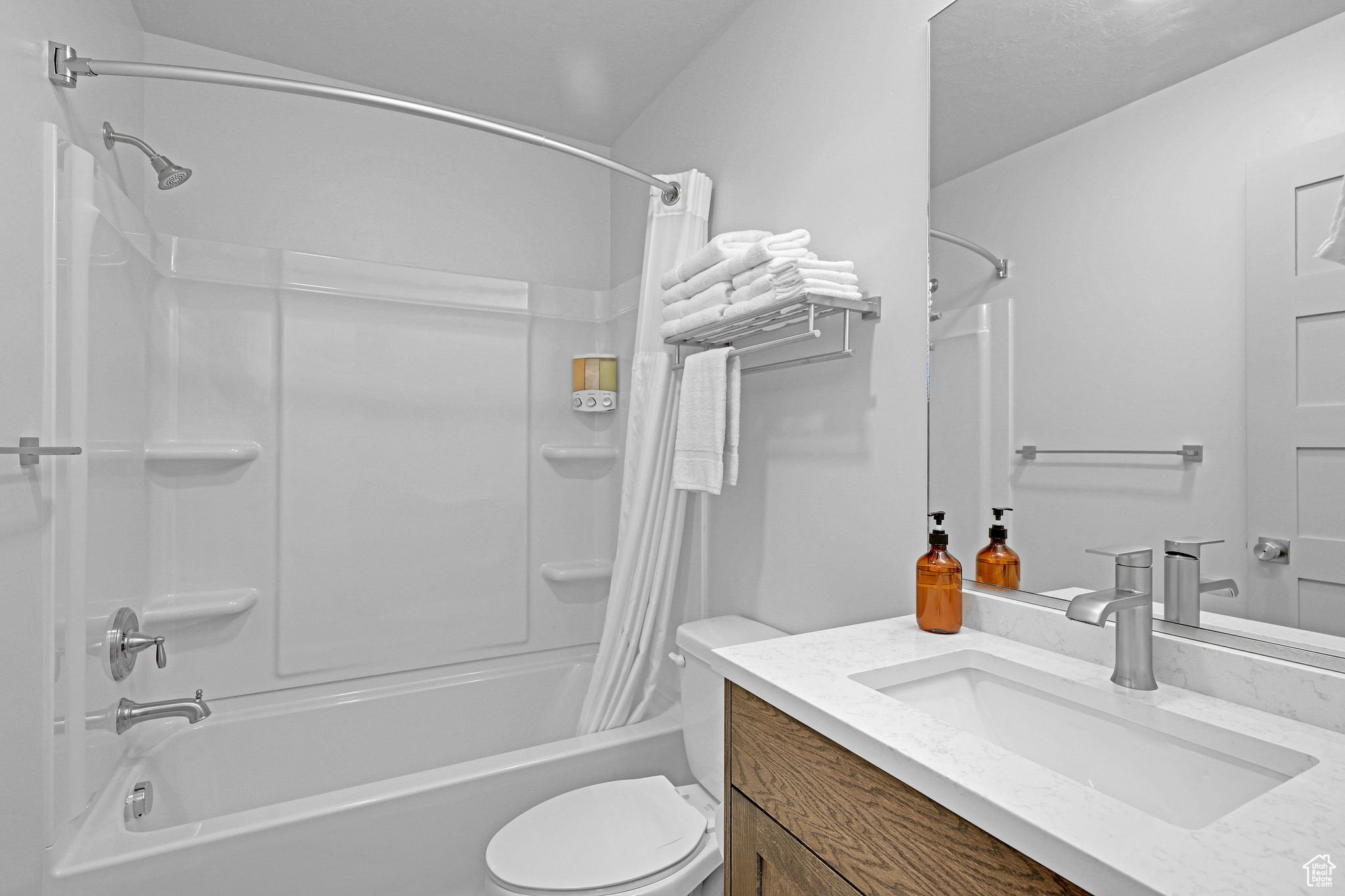 Full bath featuring vanity and shower / bath combo with shower curtain