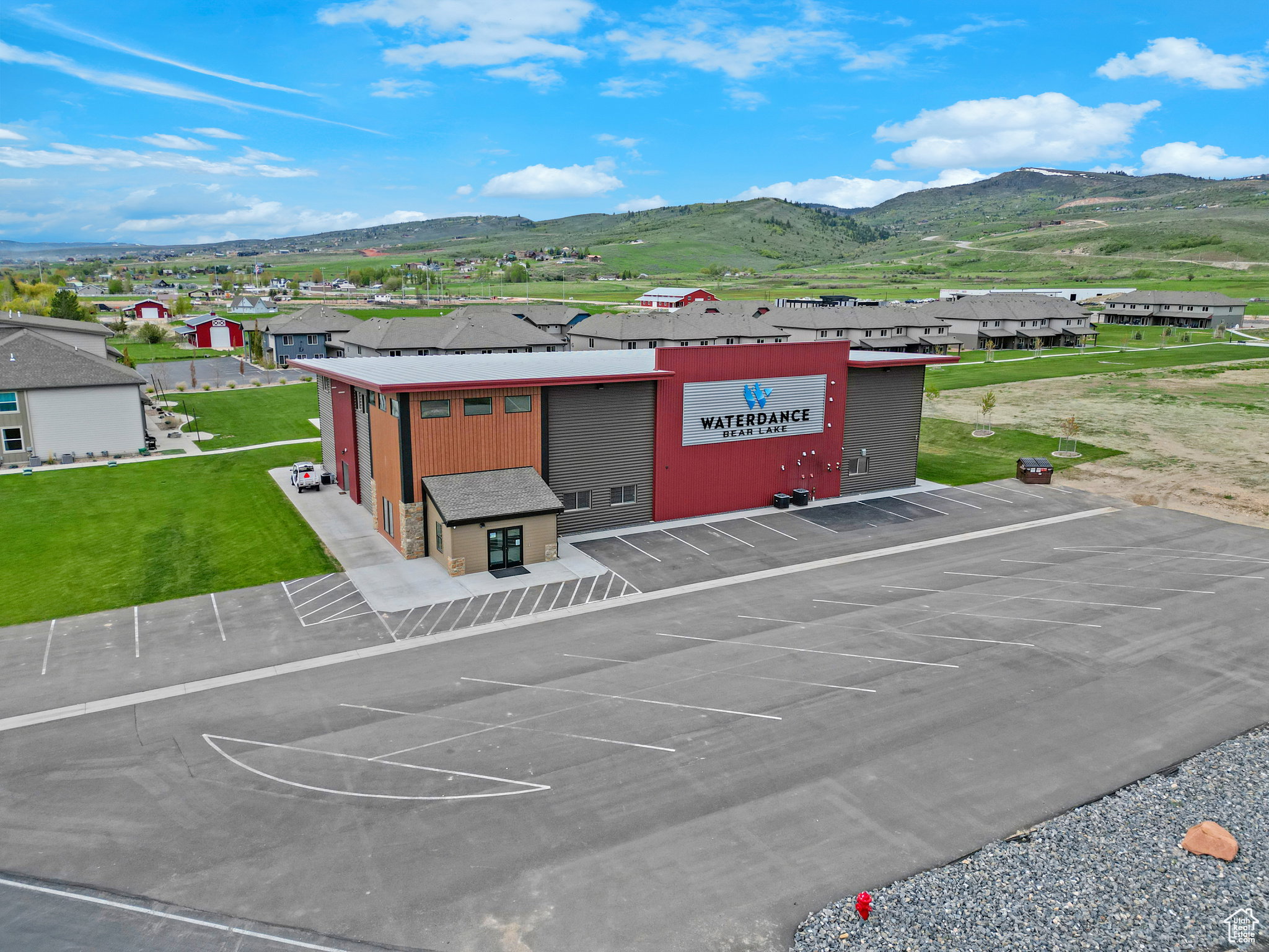 Drone / aerial view of a mountain backdrop and a commercial area