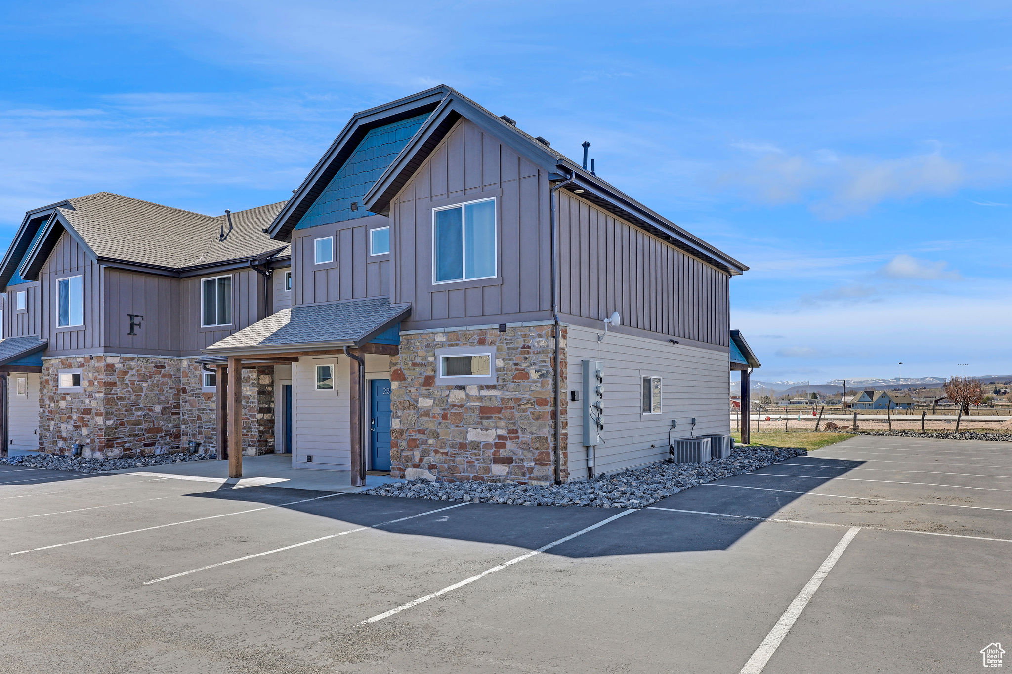 View of building exterior featuring uncovered parking and a mountain view