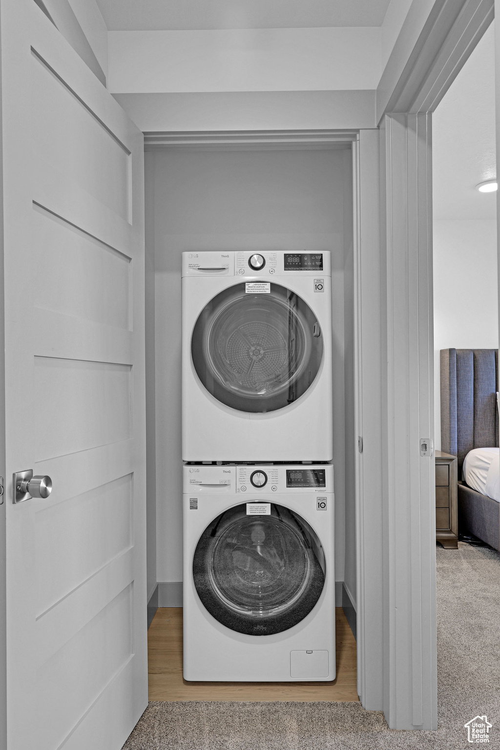 Laundry area featuring stacked washer and clothes dryer