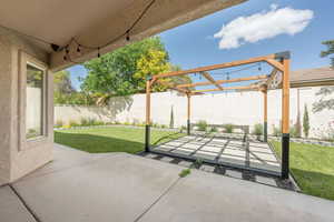 Fenced backyard with a pergola and a patio