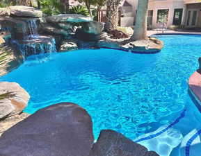 Outdoor pool with french doors and a patio