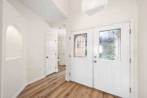Entrance foyer with french doors and light wood finished floors