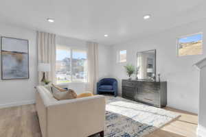Sitting room featuring light wood-style flooring and recessed lighting