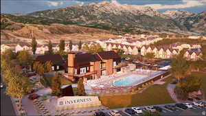 Aerial view of residential area with mountains and a pool