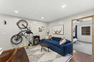 Living room with wood-type flooring and recessed lighting