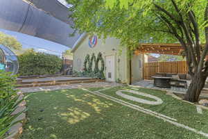 Fenced backyard featuring an outdoor hangout area, an outbuilding, and a patio area