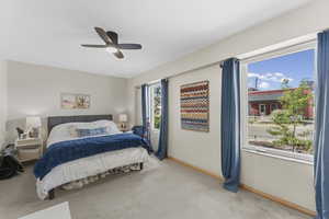 Bedroom featuring light carpet and a ceiling fan