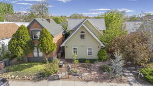 Traditional home with brick siding and a shingled roof
