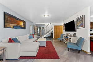 Living room featuring stairs and wood finished floors