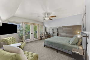 Carpeted bedroom with access to outside, a ceiling fan, french doors, and wood walls