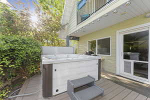 Wooden deck featuring a hot tub