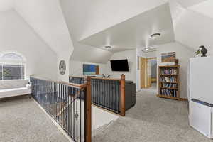 Corridor with an upstairs landing and light carpet