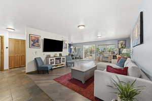 Living room with dark wood finished floors and baseboards