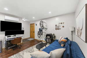 Living room with dark wood-style flooring and recessed lighting