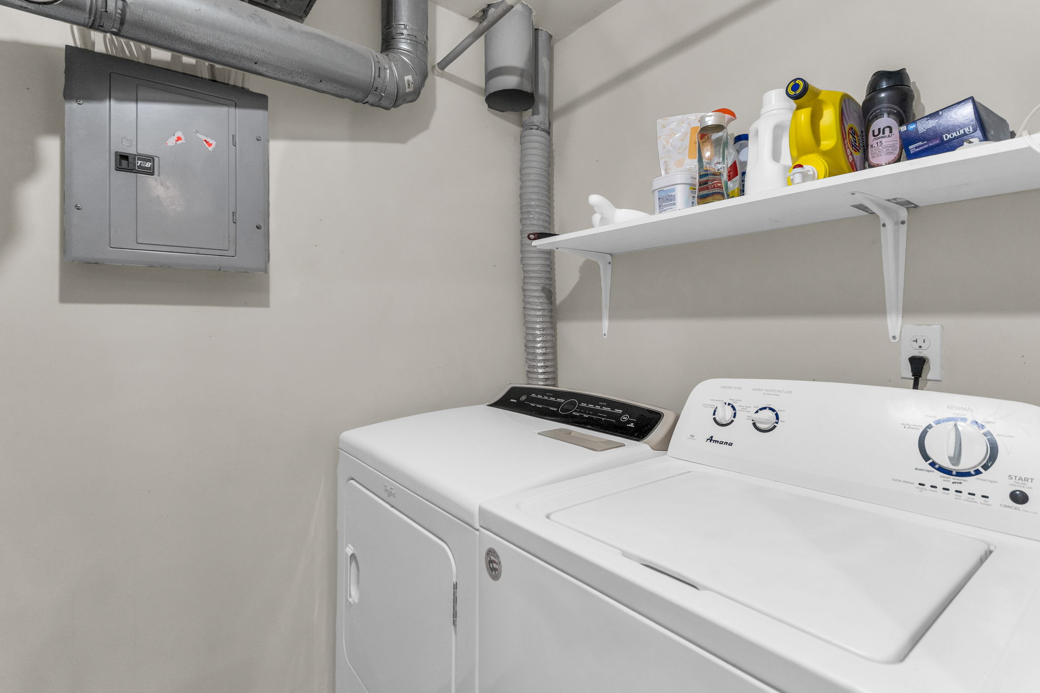 Laundry room with electric panel and washing machine and dryer