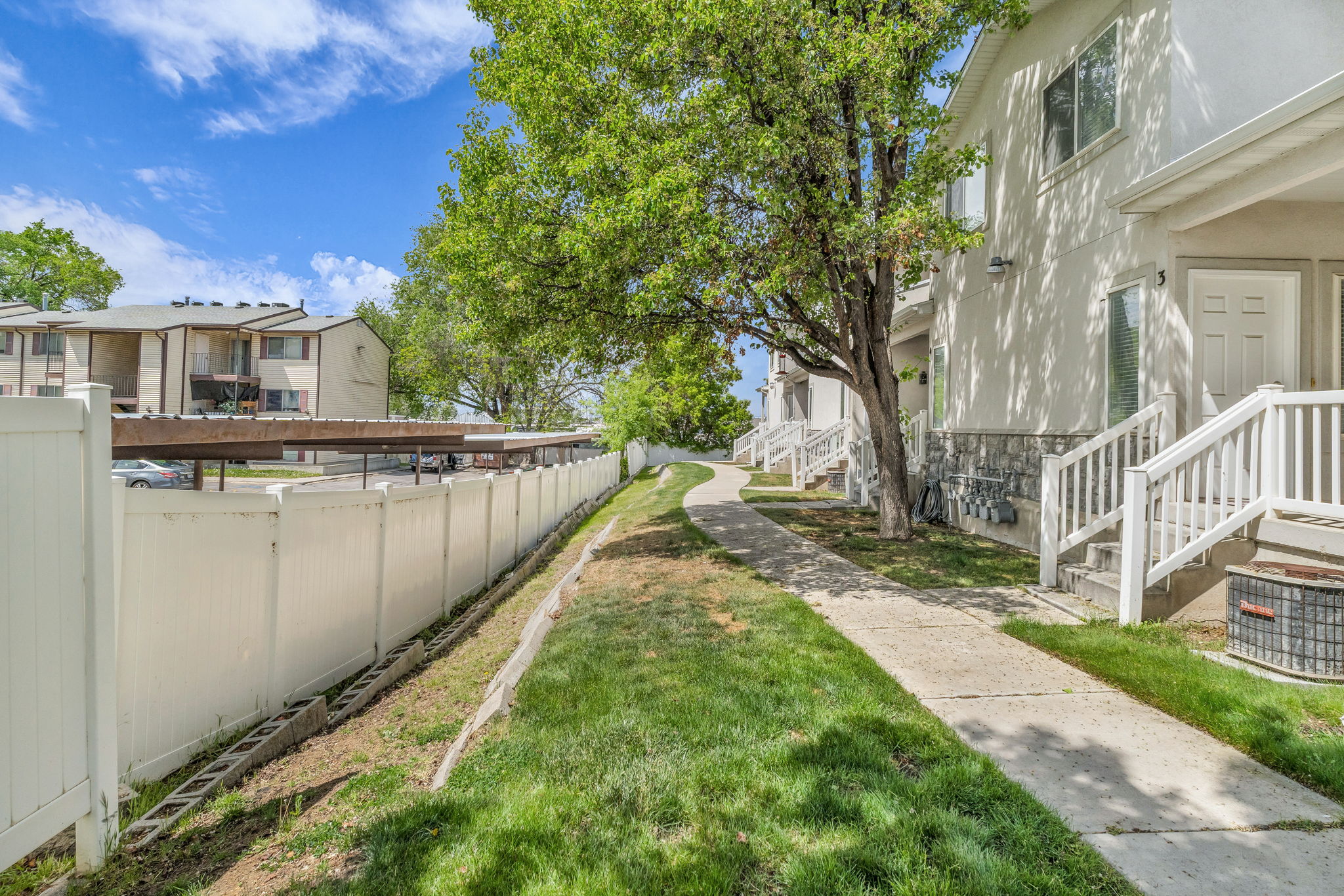 Fenced yard featuring a residential view