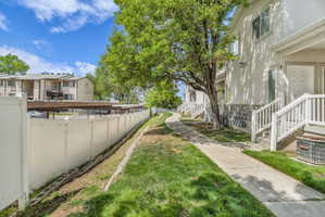 Fenced yard featuring a residential view