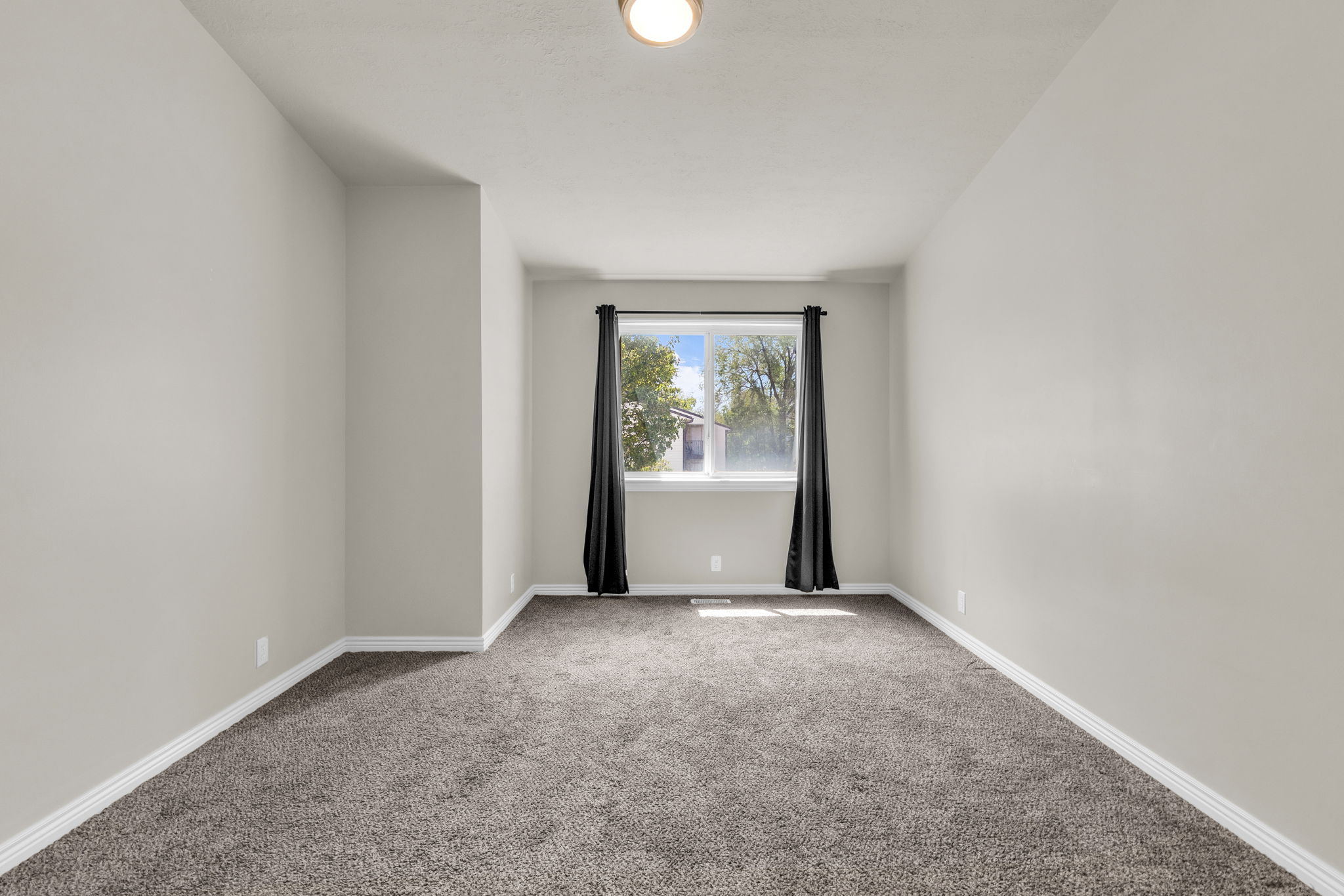Empty room with carpet flooring and baseboards