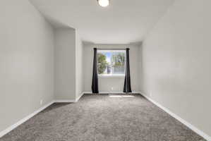 Empty room with carpet flooring and baseboards