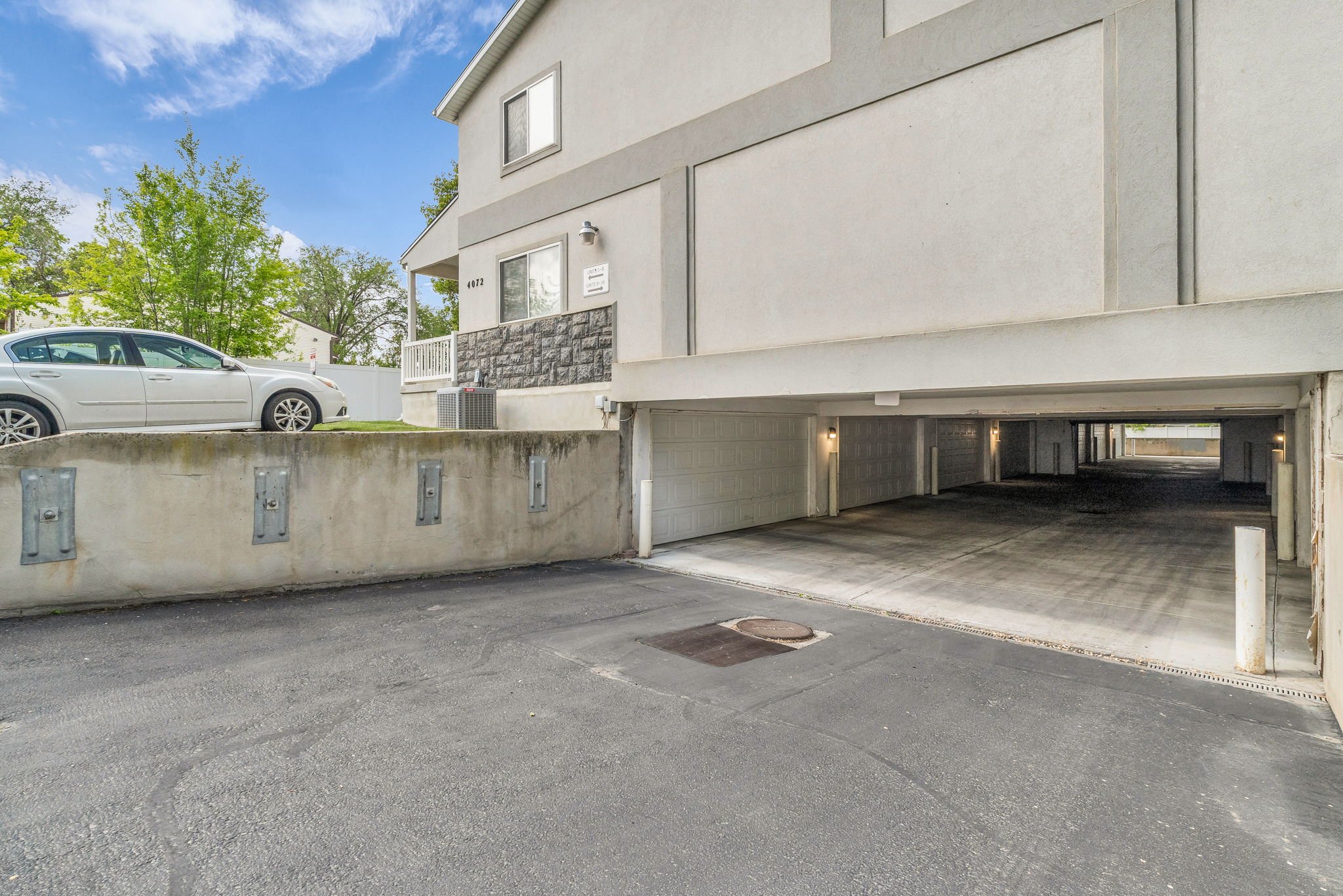 View of side of home featuring stucco siding and a garage