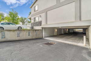 View of side of home featuring stucco siding and a garage