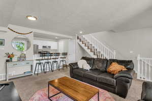Living room featuring light carpet and recessed lighting