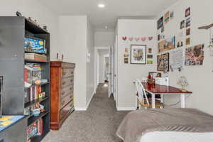 Bedroom with light carpet and baseboards